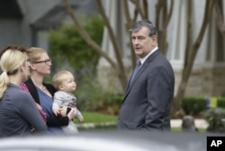 Dallas Mayor Mike Rawlings speaks to residents on the street of the apartment of a hospital worker in Dallas, Oct. 12, 2014.