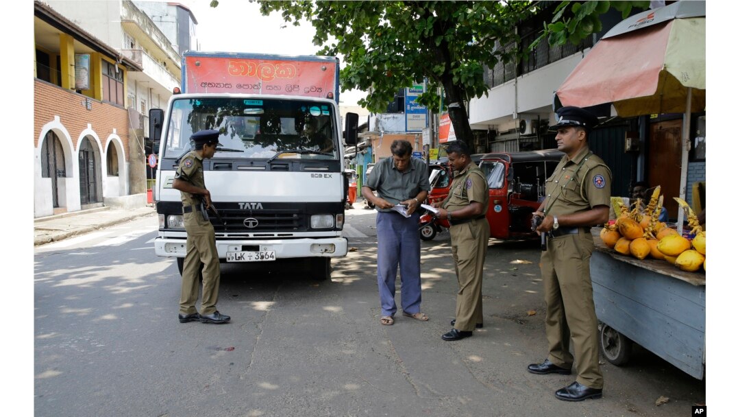 Sri Lankan police officers perform a security check on a truck at a roadside in Colombo, Sri Lanka, April 25, 2019.