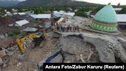 An aerial view of the collapsed Jamiul Jamaah mosque where rescue workers and soldiers search for earthquake victims in Pemenang, North Lombok, Indonesia, Aug. 8, 2018. 