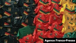 Cameroonian football jerseys hang along a wall at the central market in Yaounde on Jan. 5, 2022. The Africa Cup of Nations (CAN) starts on Jan. 9, 2022 in Cameroon after a postponement in 2021.