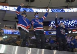 New York Rangers fans celebrate a second-period goal against the Philadelphia Flyers during an NHL hockey game at Madison Square Garden, Monday, March 15, 2021, in New York. (Bruce Bennett/Pool Photo via AP)