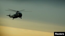 FILE - President Donald Trump arrives aboard the Marine One to greet the remains of a U.S. military commando killed during a raid on the al-Qaida militant group in southern Yemen, at Dover Air Force Base, Dover, Delaware, Feb. 1, 2017. 