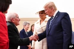 President Donald Trump shakes the hand of a World War II veteran during events marking D-Day's 75th Anniversary in Portsmouth, England, June 5, 2019.