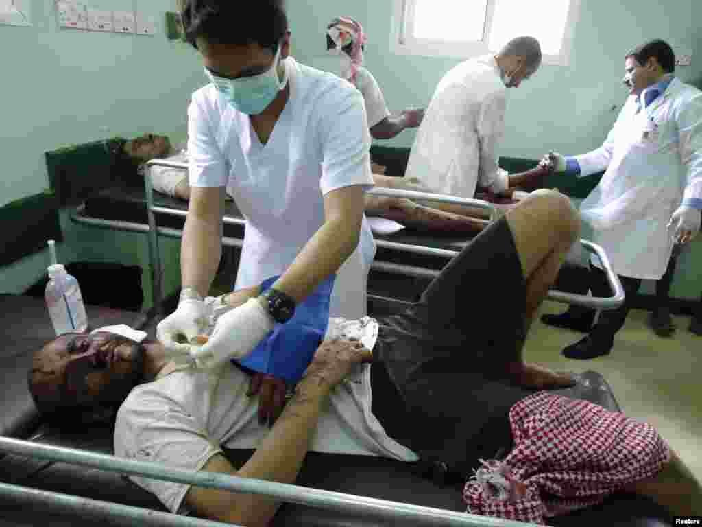 A medic attends to a man injured in an airstrike in Saada, a province in the northwestern part of Yemen, March 27, 2015.