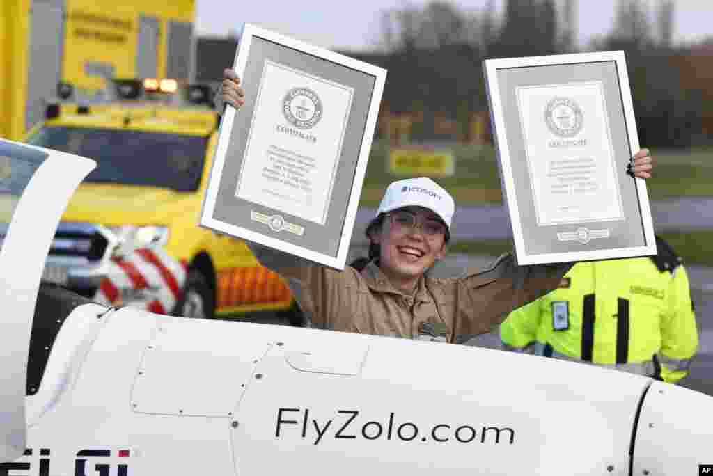 Belgium-British teenage pilot Zara Rutherford holds up her certificates after landing her Shark ultralight plane at the Kortrijk airport in Kortrijk, Belgium, Jan. 20, 2022.&nbsp;The 19-year-old has set a world record as the youngest woman to fly solo around the world, touching her small airplane down in western Belgium, 155 days after she departed.&nbsp;