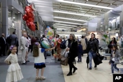 FILE - Nadia Hanan Madalo, center, and her family, refugees forced to flee their town of Batnaya, Iraq, after the Islamic State invaded and destroyed it several years ago, arrive in San Diego, California, Mar. 15, 2017.