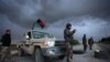 Libyan security forces stand guard at a checkpoint on the highway leading to downtown Benghazi, Libya, Feb. 15, 2013. Libyans are preparing to mark the second anniversary of the uprising that ousted Moammar Gadhafi.