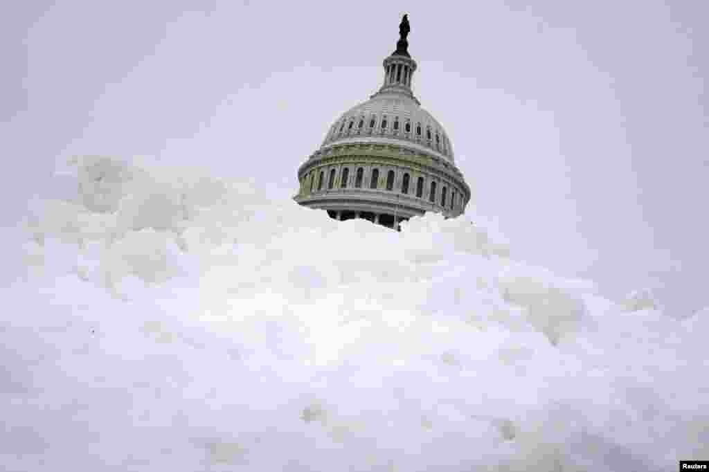 The U.S. Capitol is visible behind a snow bank following a storm, on Capitol Hill in Washington.