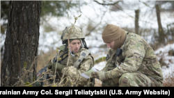 Український військовик (ліворуч) отримує підказки від американського тренера-спостерігача навчального підрозділу 7-ї Армії США під час багатонаціональних маневрів Combined Resolve XVI у Німеччині, 10 грудня 2021р.