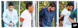 In this combination photo, four un-named alleged members of a terror cell accused of killing 15 people in attacks in Barcelona leave a Civil Guard base on the outskirts of Madrid before appearing in court in Madrid, Spain, Aug. 22, 2017.