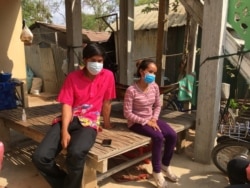 Seang Naroth and Seng Va seated at their family home in Bati district, Takeo province, a day after they completed their 14-day isolation period on April 7, 2020. (Ananth Baliga/VOA Khmer)