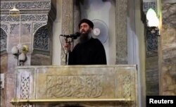 A man purported to be the reclusive leader of the militant Islamic State Abu Bakr al-Baghdadi has made what would be his first public appearance at a mosque in the centre of Iraq's second city, Mosul, according to a video recording posted on the Internet on July 5, 2014, in this still image taken from video. Social Media Website via Reuters TV/File Photo