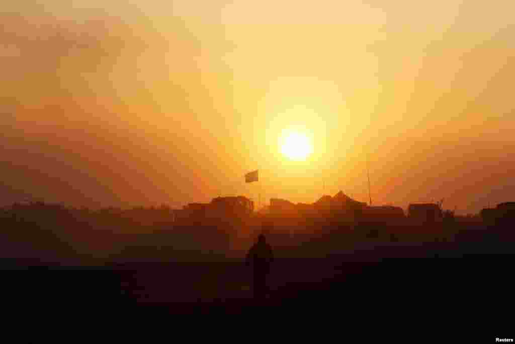 An Israeli soldier walks near the border with the Gaza Strip, Aug. 1, 2014.