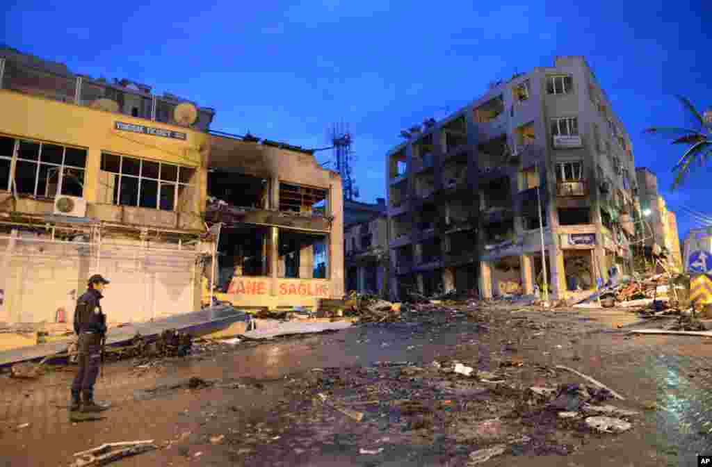 Damaged buildings and debris from one of the Saturday explosions that killed 46 and injured about 50 others, in Reyhanli, near Turkey's border with Syria, May 12, 2013.
