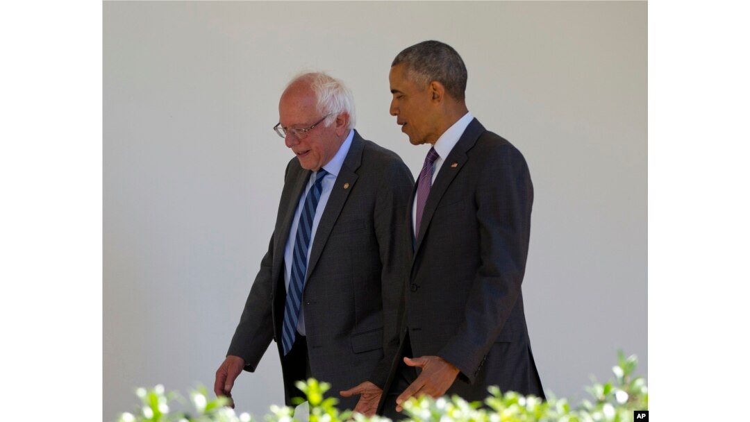 President Barack Obama walks with Democratic presidential candidate Sen. Bernie Sanders, I-Vt., down the Colonnade of the White House in Washington, June 9, 2016.