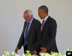 President Barack Obama walks with Democratic presidential candidate Sen. Bernie Sanders, I-Vt., down the Colonnade of the White House in Washington, June 9, 2016.