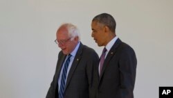 President Barack Obama walks with Democratic presidential candidate Sen. Bernie Sanders, I-Vt., down the Colonnade of the White House in Washington, June 9, 2016.