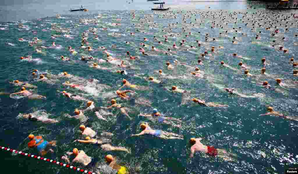 People participate in the annual public Lake Zurich crossing swimming event in Zurich, Switzerland.