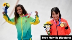 Rayssa Leal and Momiji Nishiya of Japan pose with their skateboarding medals.