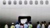 Indonesia soldiers and rescue personnel put a coffin of a passenger of AirAsia Flight QZ8501 into the cargo compartment of a Trigana airplane, file photo. 