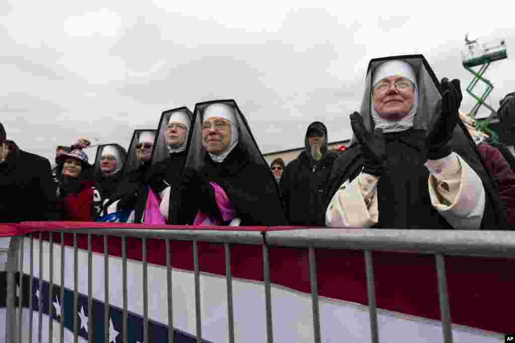 Nuns with the Dominican Sisters of Hartland, Mich., applaud as President Donald Trump speaks at a campaign rally at Oakland County International Airport, Friday, Oct. 30, 2020, at Waterford Township, Mich. (AP Photo/Alex Brandon)