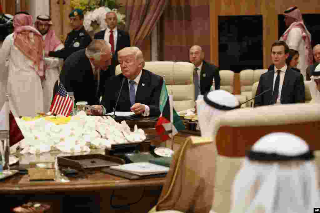 U.S. Secretary of State Rex Tillerson, left, speaks with President Donald Trump during a meeting with leaders at the Gulf Cooperation Council Summit, at the King Abdulaziz Conference Center in Riyadh, Saudi Arabia, May 21, 2107.