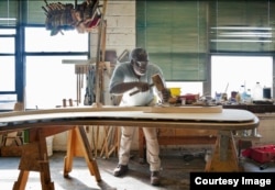 A craftsman works on a Steinway piano in the company's Astoria, New York, factory. (Photo courtesy of Steinway & Sons)