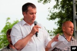 FILE - Anatoly Bokun, leader of strike committee at Belaruskali, a huge potash factory in Soligorsk, speaks to workers in Soligorsk, Belarus, Wednesday, Aug. 19, 2020.