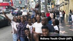 In this handout photo provided by Ndlovu Youth Choir and taken March 2019, chorus members pose for a selfie in Los Angeles. (Ralf Schmitt/Ndlovu Youth Choir via AP)