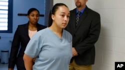 FILE - Cyntoia Brown enters her clemency hearing at Tennessee Prison for Women in Nashville, Tennessee, May 23, 2018.