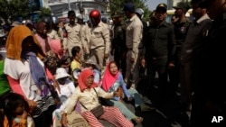 Farmers of Koh Kong province protesting land evictions are blocked by security during a protest rally as it moves near the Prime Minister's residence, in Phnom Penh, Cambodia, Tuesday, Feb. 14, 2017. Government security on Tuesday prevented the protesters from submitting a petition to Prime Minister Hun Sen at his residence to help solve their long-running land dispute with a local tycoon who owns sugarcane plantations they accuse of grabbing their land. (AP Photo/Heng Sinith)