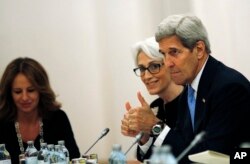 U.S. Secretary of State John Kerry and Under Secretary for Political Affairs Wendy Sherman, center, meet with foreign ministers during the current round of nuclear talks with Iran being held in Vienna, Austria, July 10, 2015.