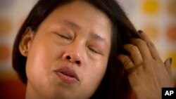 Deng Guilian cries during an interview in her hotel room in Ganzhou in southern China's Jiangxi Province, June 6, 2017. They took her husband, then tried to silence her. 