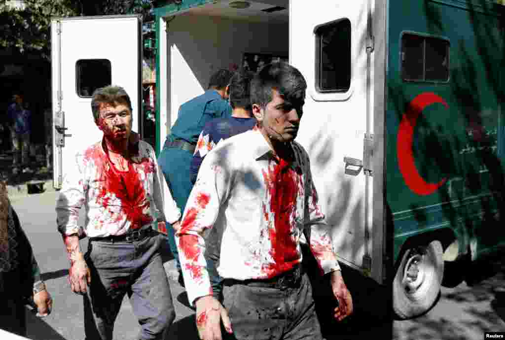 Injured Afghan men arrive at a hospital after a blast in Kabul, Afghanistan, May 31, 2017.