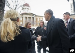 President Barack Obama, prior to his speech to the Illinois General Assembly, stops to greet people across from the Old State Capitol building in Springfield, Ill., Feb. 10, 2016.