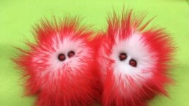 This image released by Amy Micallef shows plush toy representations of COVID-19. Micallef, a Broadway seamstress who has worked in the wardrobe departments of “Hamilton,” “Waitress” and “Frozen,” sells the toys as her side hustle, while Broadway production.