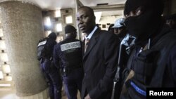 General Bruno Dogbo Ble, former commander of the Republican Guard under the regime of former President Laurent Gbagbo, is escorted to his trial in Abidjan October 2, 2012.