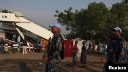 FILE - U.N. police officers patrol a United Nations camp for internally displaced persons in Juba.