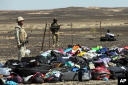 Egyptian Army soldiers stand near luggage and personal effects of passengers a day after a passenger jet bound for St. Petersburg, Russia crashed in Hassana, Egypt, Nov. 1, 2015.