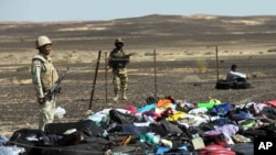 Egyptian Army soldiers stand near luggage and personal effects of passengers a day after a passenger jet bound for St. Petersburg, Russia crashed in Hassana, Egypt, Nov. 1, 2015. 