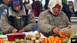 FILE - Vendors sell vegetables at a city market in Bishkek city market in Bishkek, Kyrgyzstan.