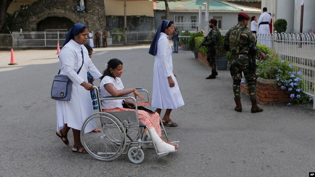 Sri Lankan Catholic nuns push a wheelchair carrying a survivor of the Easter attack for a holy mass held to bless the victims of the attacks in Colombo, Sri Lanka, May 11, 2019.