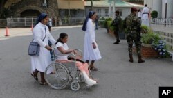 Sri Lankan Catholic nuns push a wheelchair carrying a survivor of the Easter attack for a holy mass held to bless the victims of the attacks in Colombo, Sri Lanka, May 11, 2019.