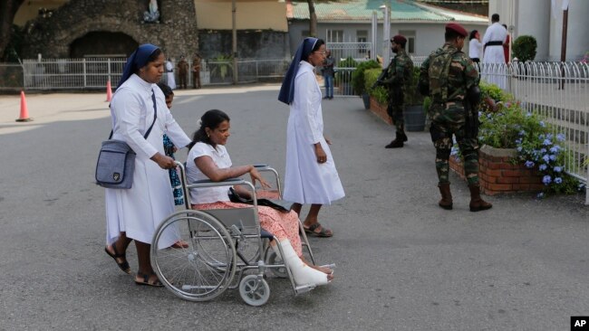 Sri Lankan Catholic nuns push a wheelchair carrying a survivor of the Easter attack for a holy mass held to bless the victims of the attacks in Colombo, Sri Lanka, May 11, 2019.