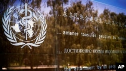 FILE - The logo of the World Health Organization is seen at the WHO headquarters in Geneva, Switzerland.