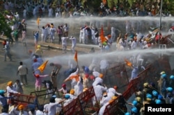 Demonstrators are hit by police water cannon during a protest, organized by Punjab's main opposition party Shiromani Akali Dal, demanding debt waiver of farmers in Chandigarh, India, March 20, 2018.