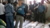 Handout photo released by Syrian opposition's Shaam News Network shows UN observers at hospital morgue before their burial in central Syrian town of Houla on May 26, 2012.