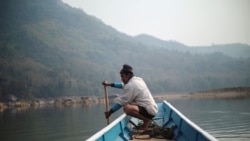 A local villager drive a boat where the future site of the Luang Prabang dam will be on the Mekong River, outskirt of Luang Prabang province, Laos, February 5, 2020