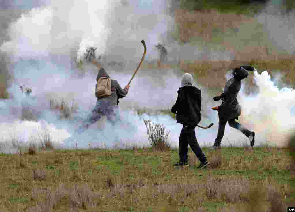 Mapuche indigenous people clash with the police during a protest against the Chilean government to demand the release of an imprisoned spiritual authority, or &quot;machi,&quot; in Comuna Imperial, Aug. 17, 2020.