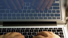 FILE - In this Feb. 27, 2013, file photo illustration, hands type on a computer keyboard in Los Angeles.